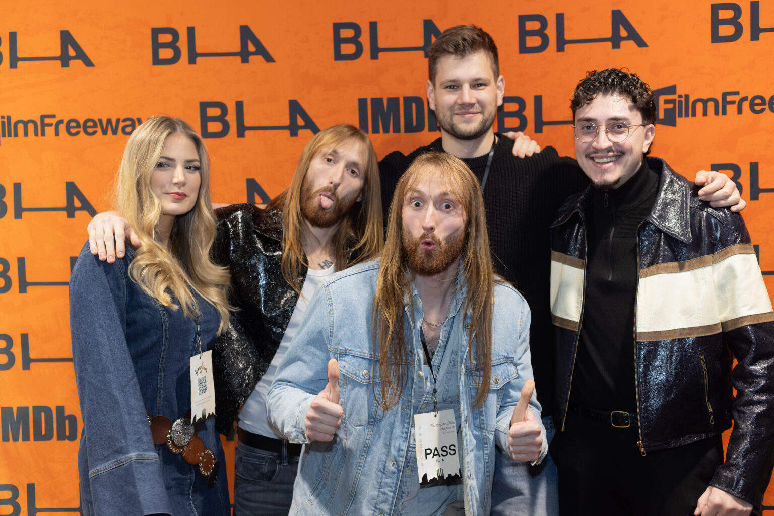 A filmmaking team poses in front of the Barcelona Indie Awards press wall