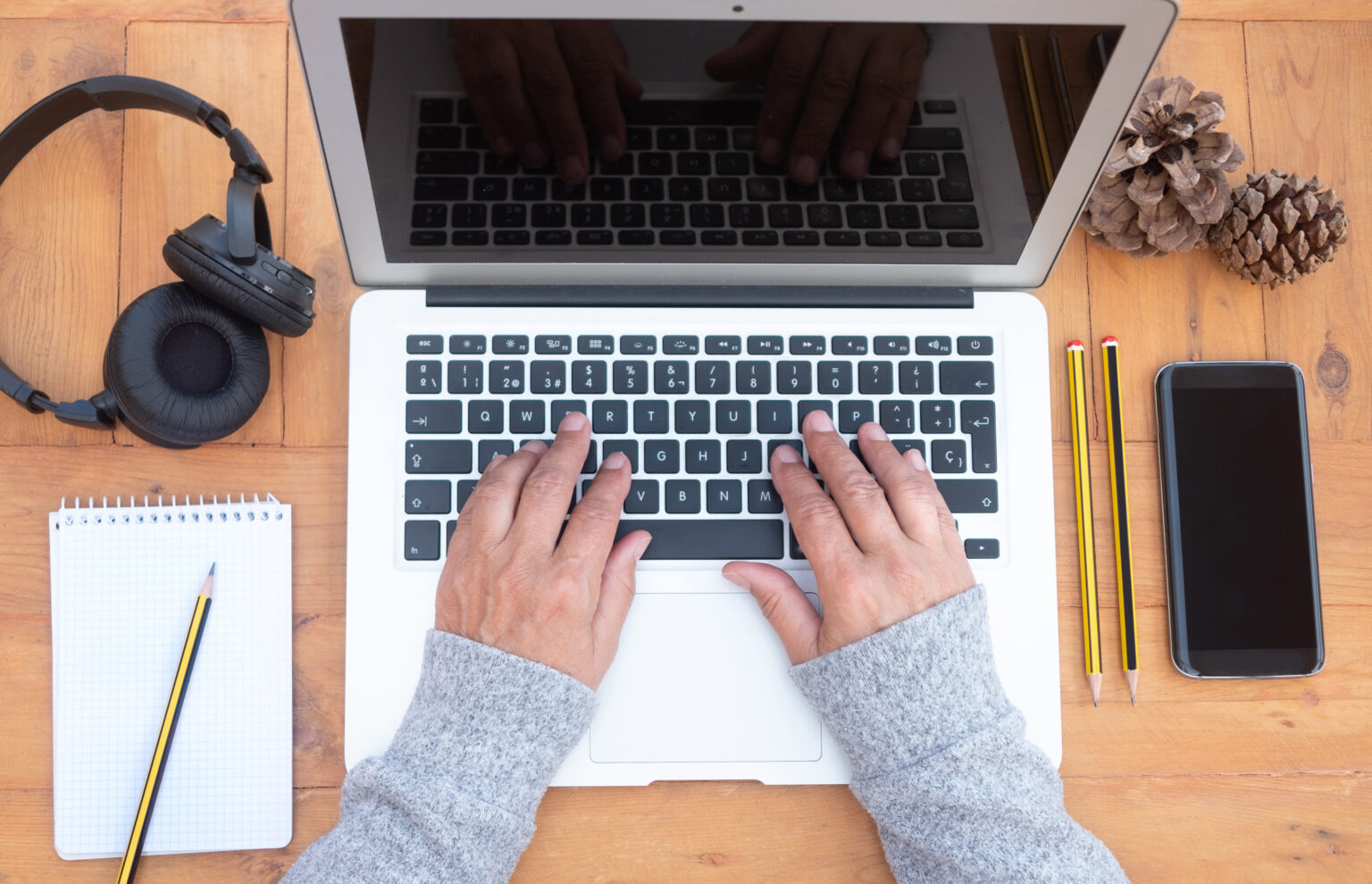 Overhead view of hands working on a laptop
