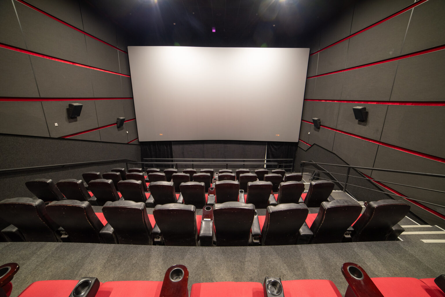 Empty cinema auditorium with rows of seats facing the screen