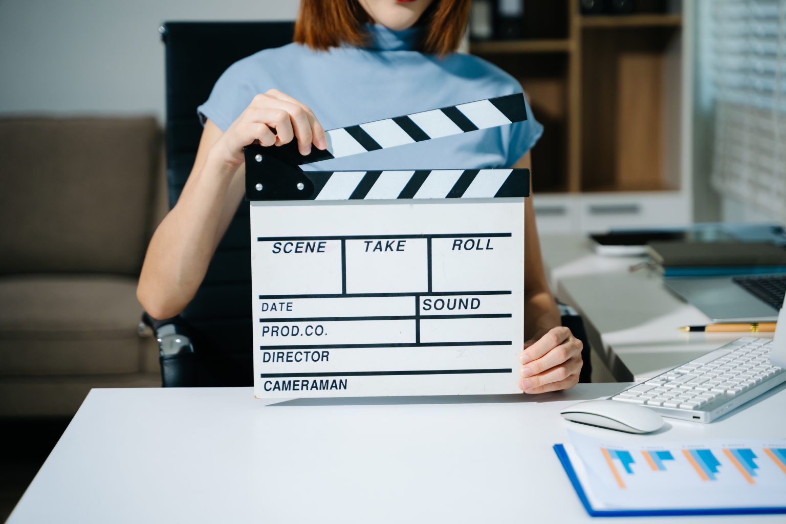 Filmmaker using a clapperboard in a modern studio space