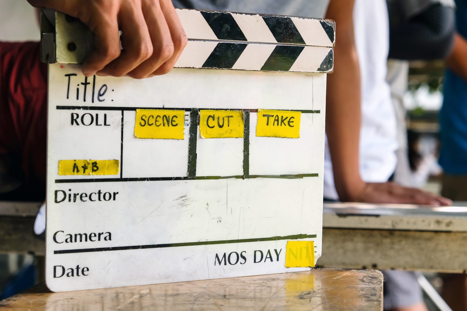 Film production crew marking a scene with a film slate