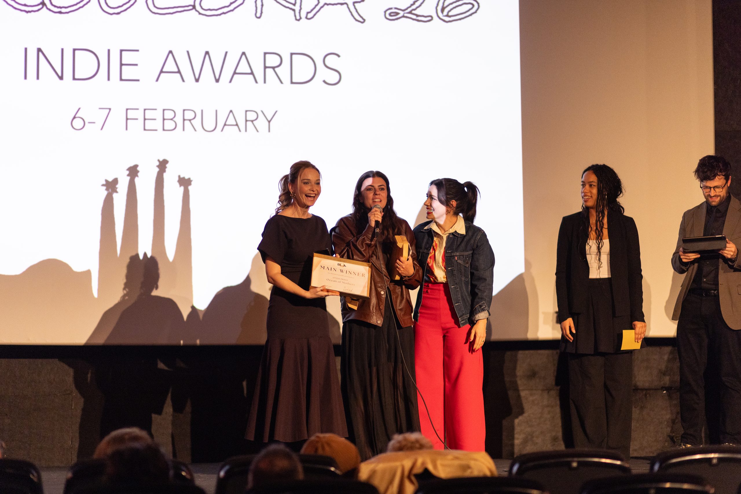 Winners accepting the Main Winner award on stage at Cine Maldà